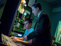 David sanders with student in broadcast production booth